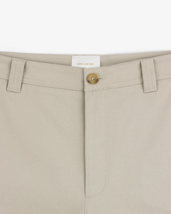 Close-up of Officer Pant waistband featuring a button closure and belt loops against a white background.