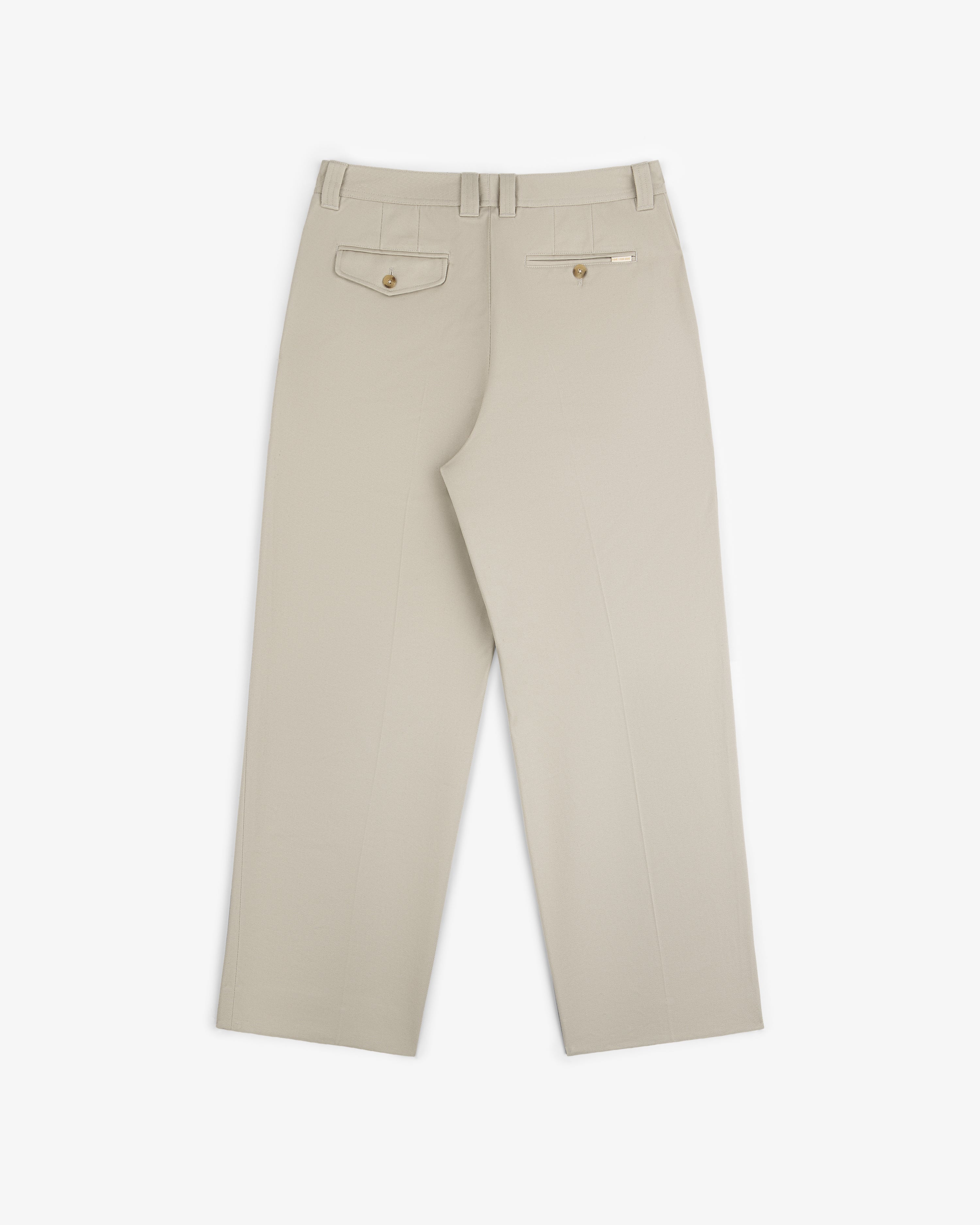 Officer Pant in beige with back welt pockets and belt loops, laid flat on a white background, back view shown.