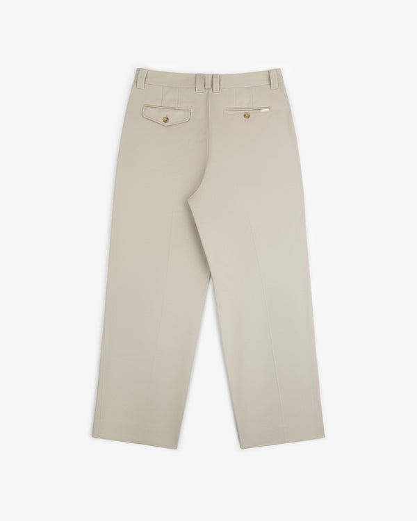 Officer Pant in beige with back welt pockets and belt loops, laid flat on a white background, back view shown.