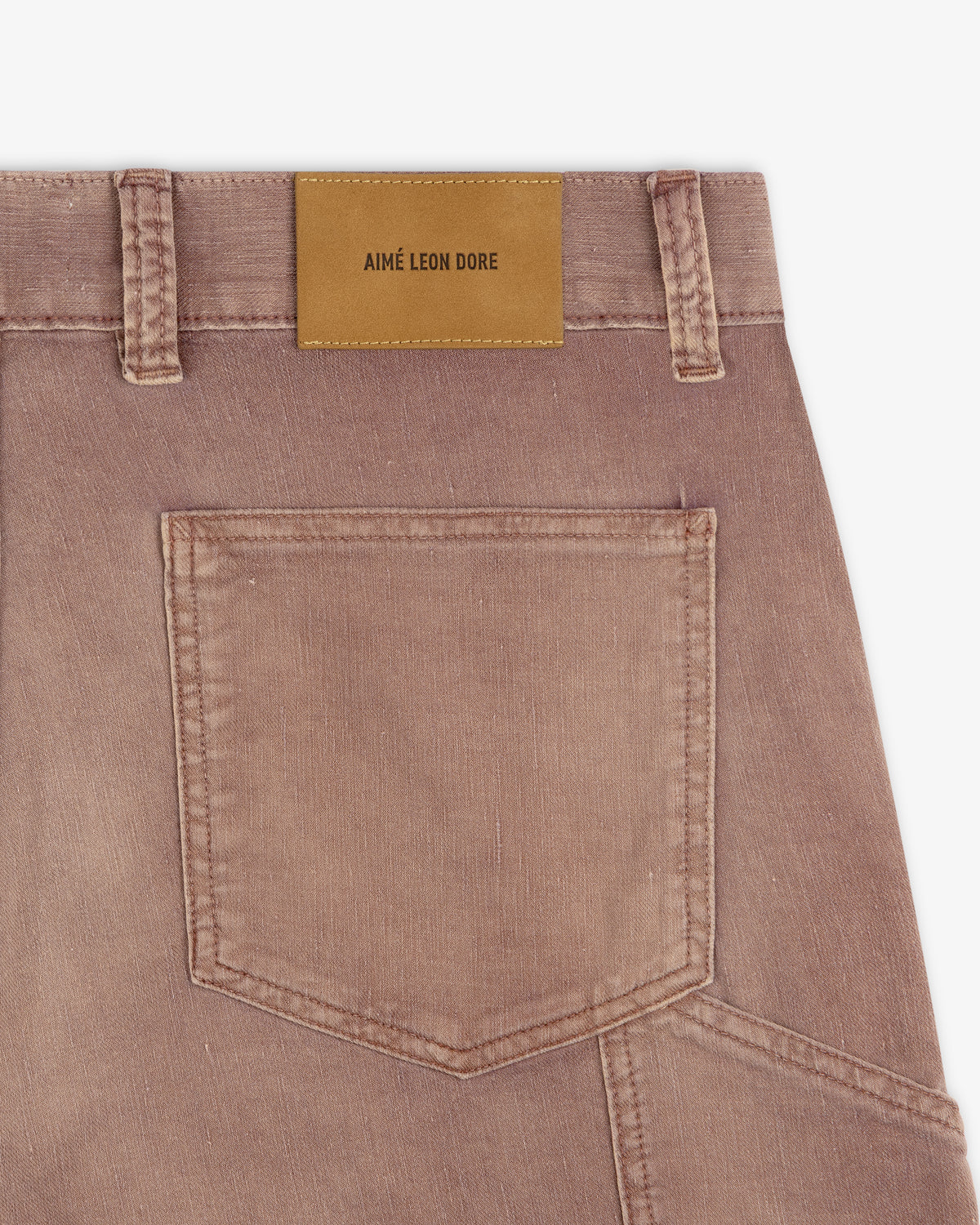 Close-up of Linen Blend Carpenter Pant in faded brown with back pocket and tan Aimé Leon Dore label on waistband.