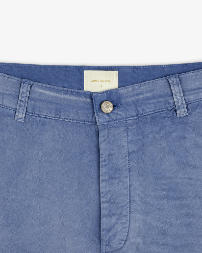 Close-up of the waistband and button on Linen Blend Carpenter Pant in light blue with belt loops and a white inside label.