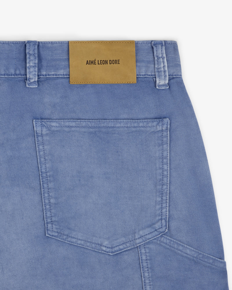 Close-up of light blue Linen Blend Carpenter Pant with a tan leather Aimé Leon Dore patch above the back pocket.