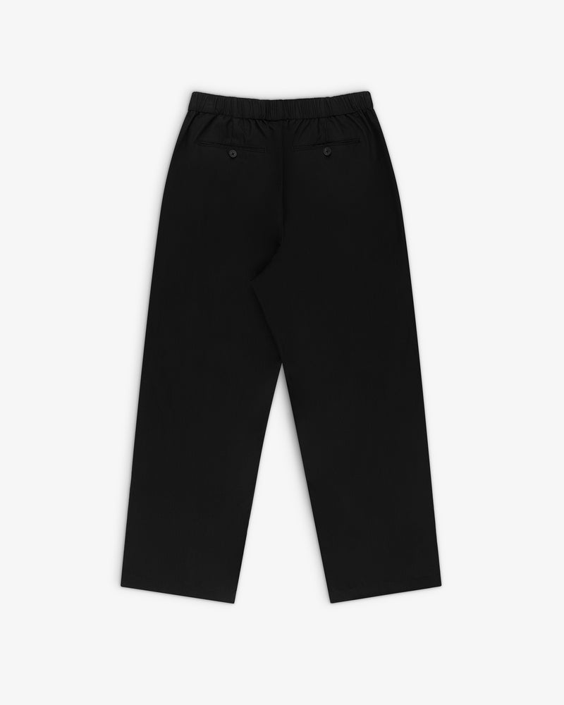 Relaxed Cotton Trouser in black with an elastic waistband and two back pockets, shown laid flat on white.