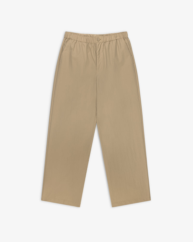Relaxed Cotton Trouser in beige, straight-leg with elastic waistband and side pockets, shown on white background.