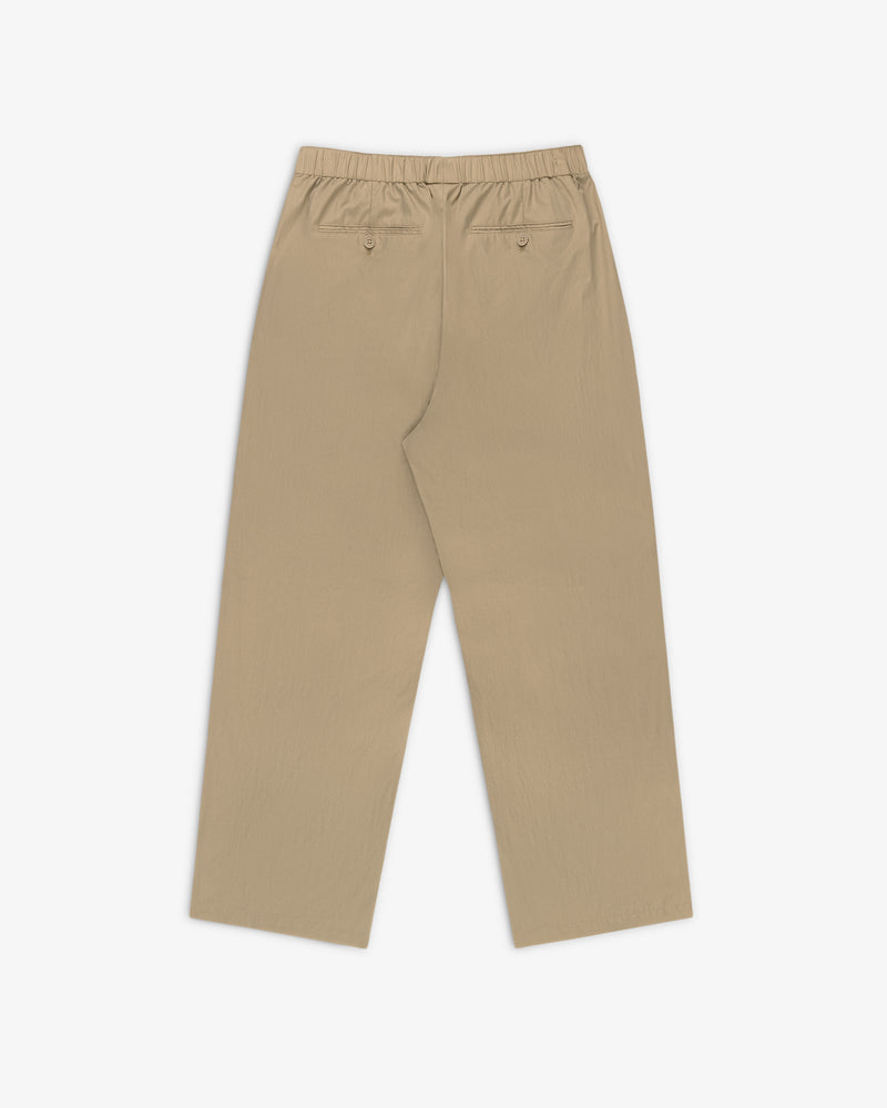 Relaxed Cotton Trouser in beige with straight legs, elastic waistband, and two back pockets on a white background.