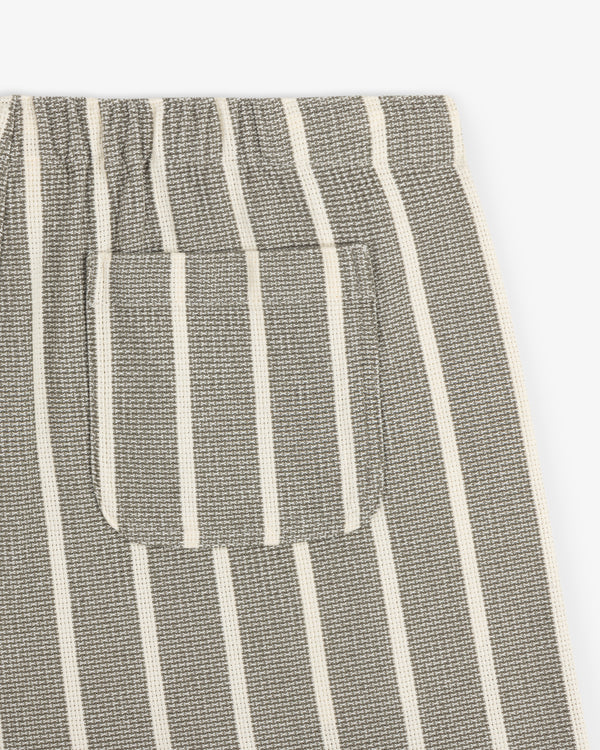 Close-up of Wide Leg Shore Pant in gray with white stripes, small patch pocket, and elastic waistband.