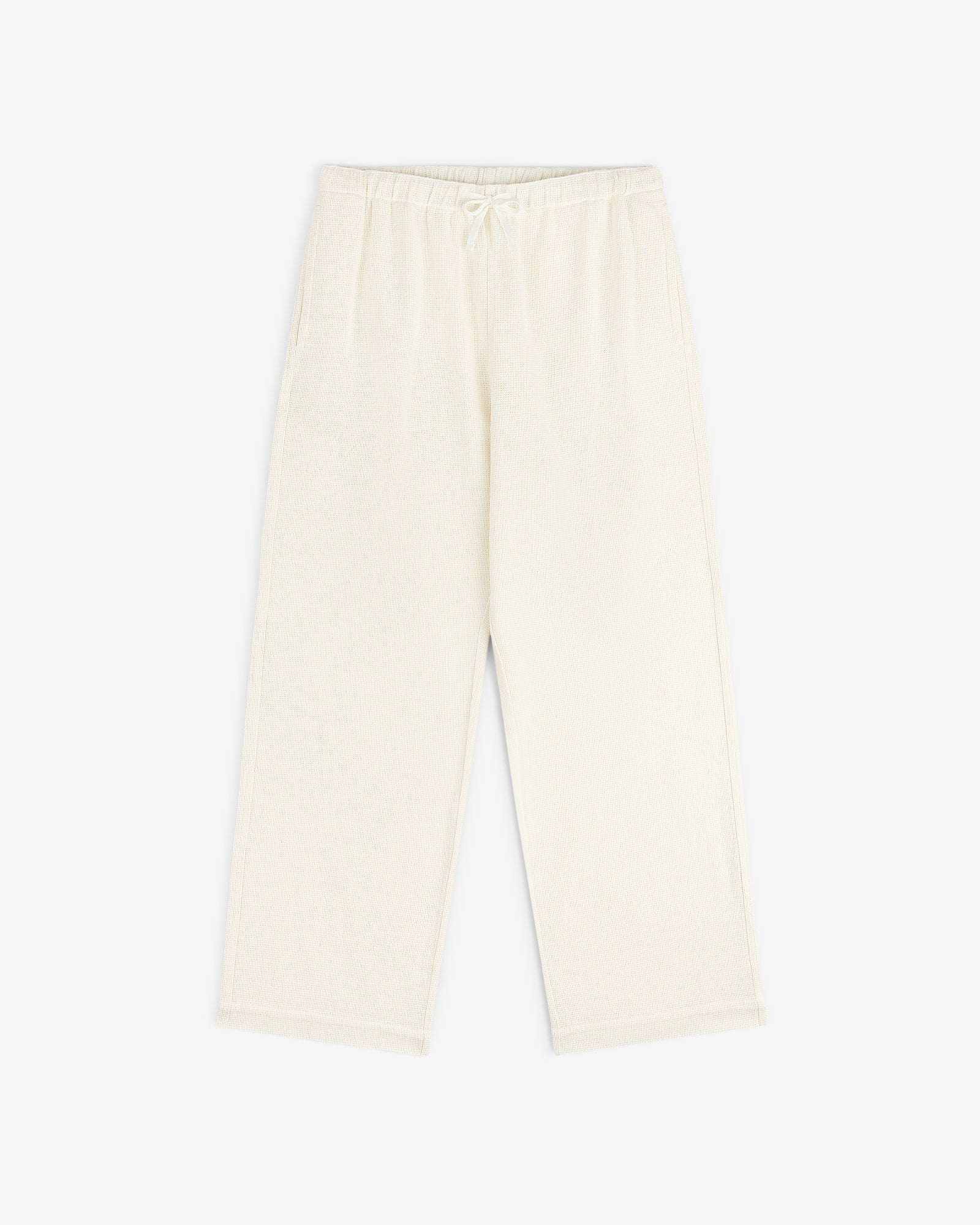 Cream-colored Wide Leg Shore Pant with an elastic waistband and side pockets, laid on a white background.