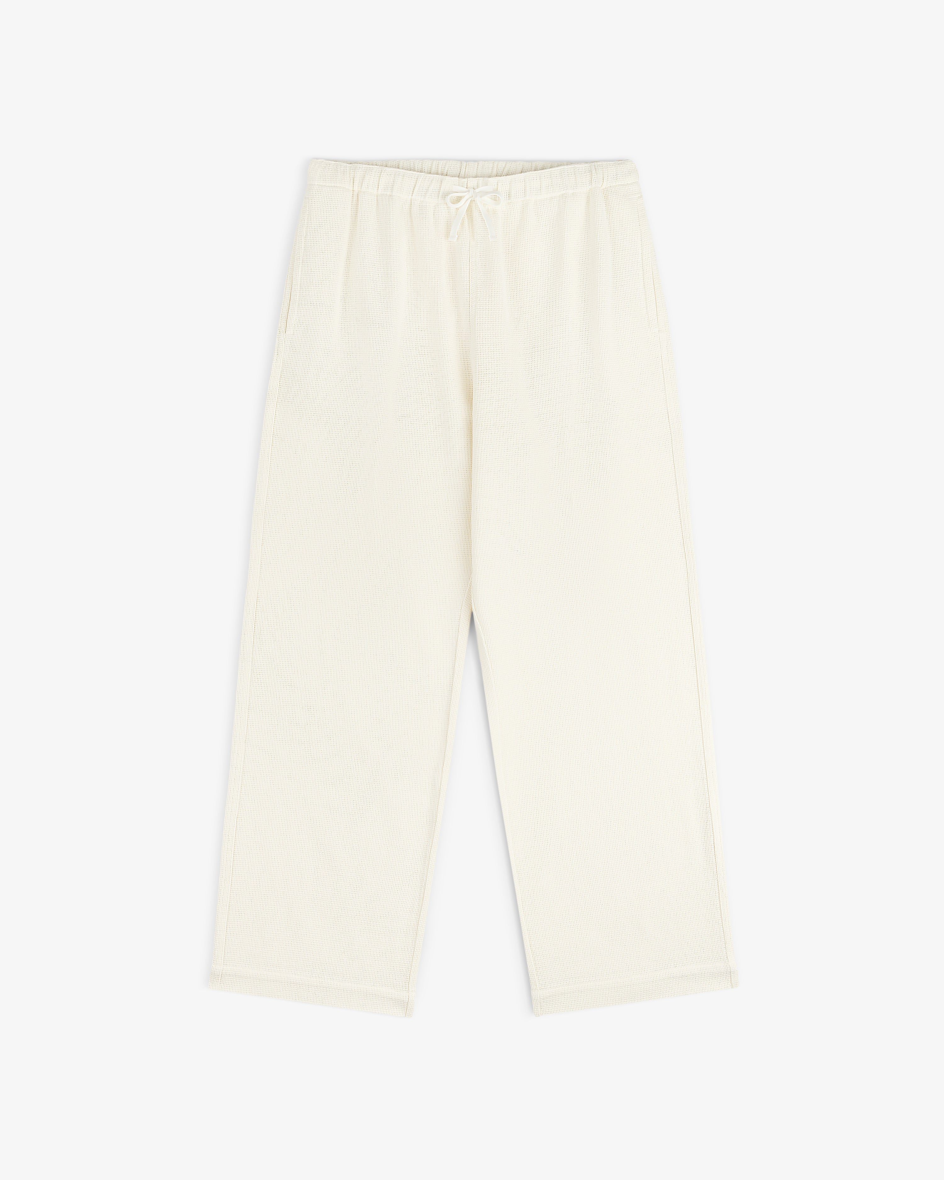 Cream-colored Wide Leg Shore Pant with an elastic waistband and side pockets, laid on a white background.