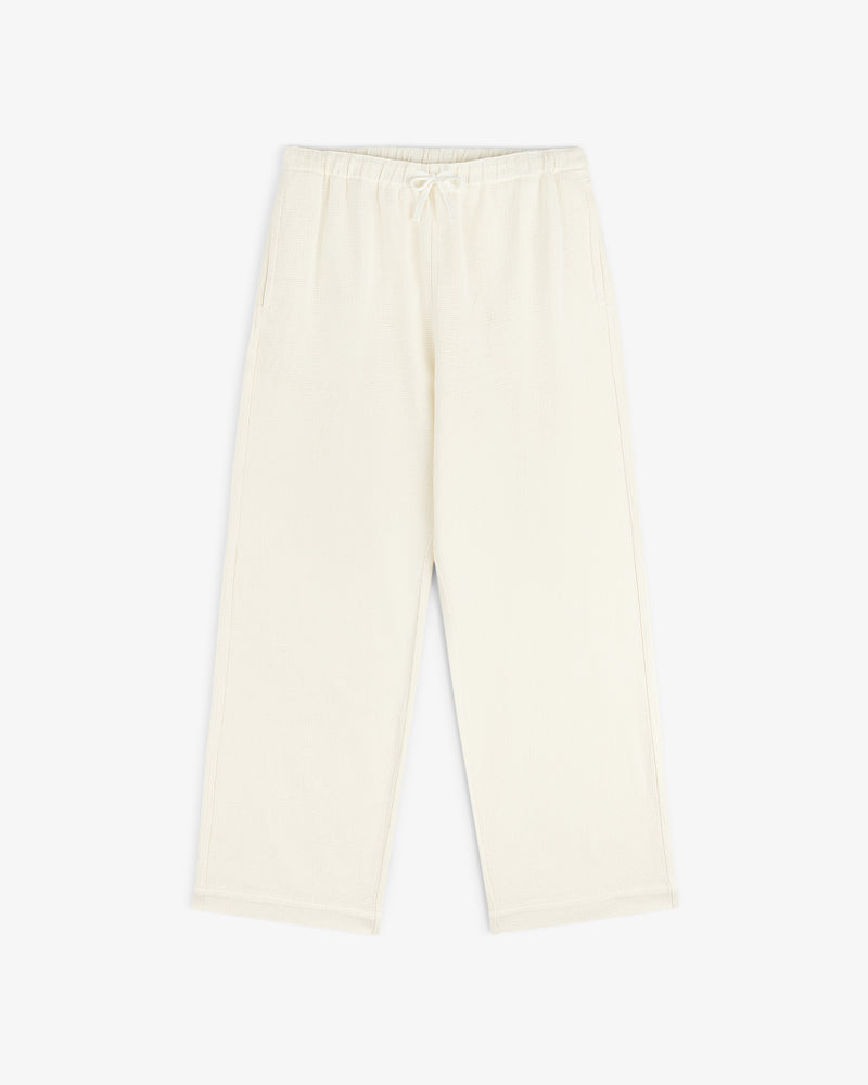 Cream-colored Wide Leg Shore Pant with an elastic waistband and side pockets, laid on a white background.