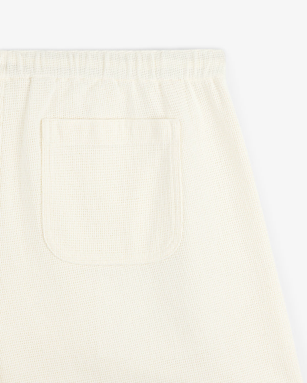 Close-up of the back pocket on cream Wide Leg Shore Pant with a textured finish and elastic waistband.