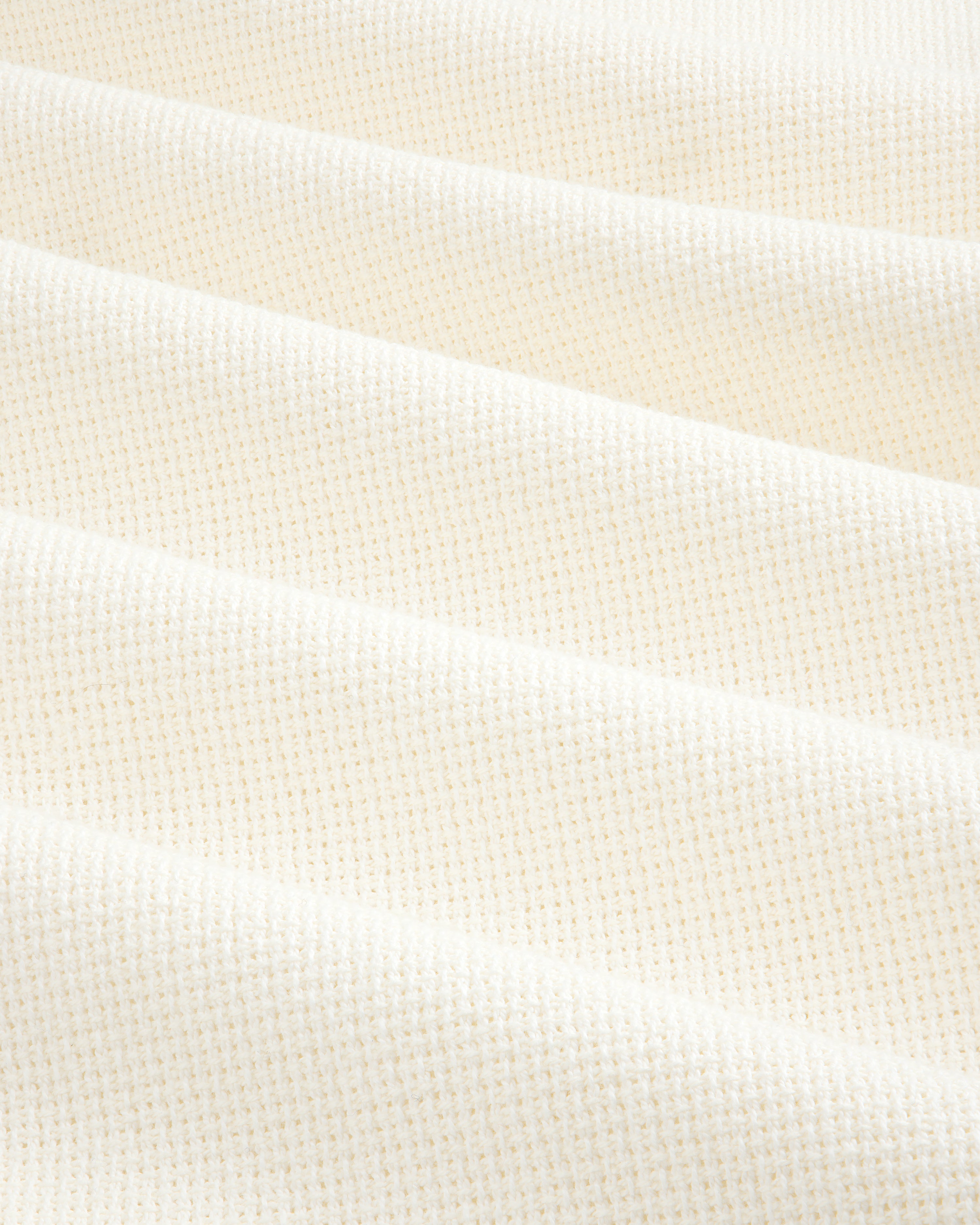 Wide Leg Shore Pant in cream-colored textured fabric with a small grid pattern, shown in soft, diagonal folds.