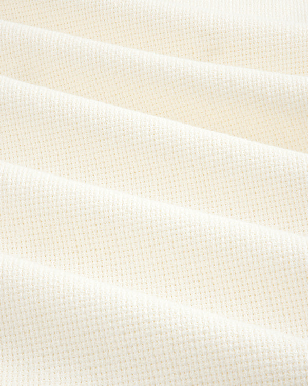 Wide Leg Shore Pant in cream-colored textured fabric with a small grid pattern, shown in soft, diagonal folds.