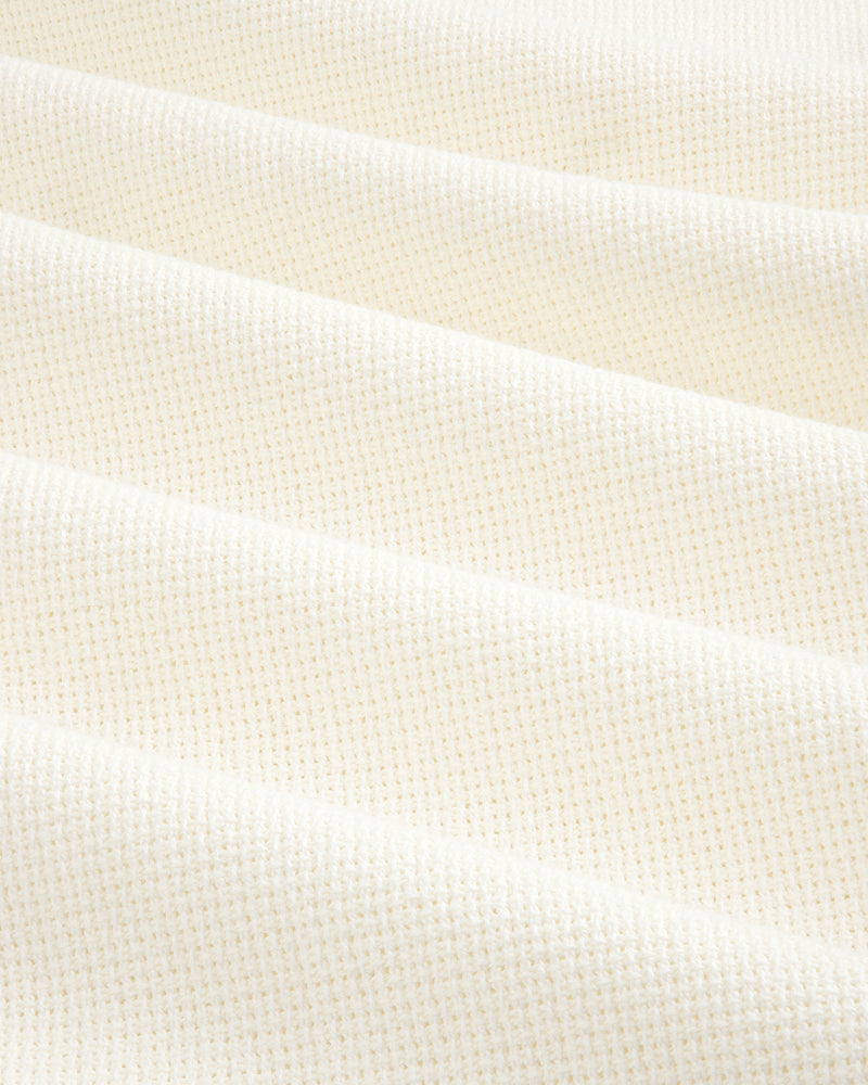 Wide Leg Shore Pant in cream-colored textured fabric with a small grid pattern, shown in soft, diagonal folds.