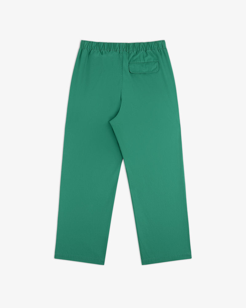 Washed Cotton Windbreaker Pant in green with elastic waistband and back pocket, laid flat on white background.