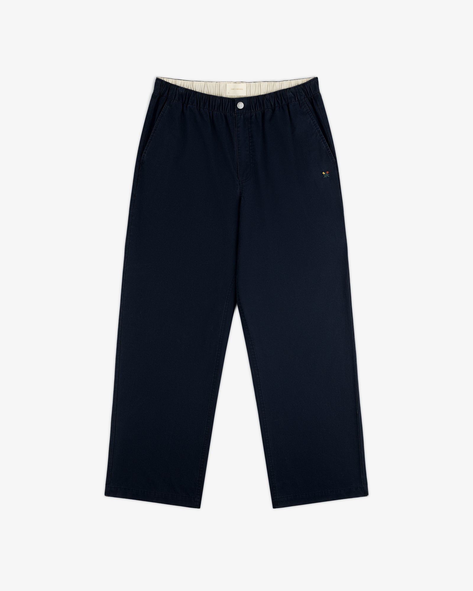 Washed Cotton Windbreaker Pant in navy with wide legs, elastic waist, side pockets, and embroidered logo by left pocket.