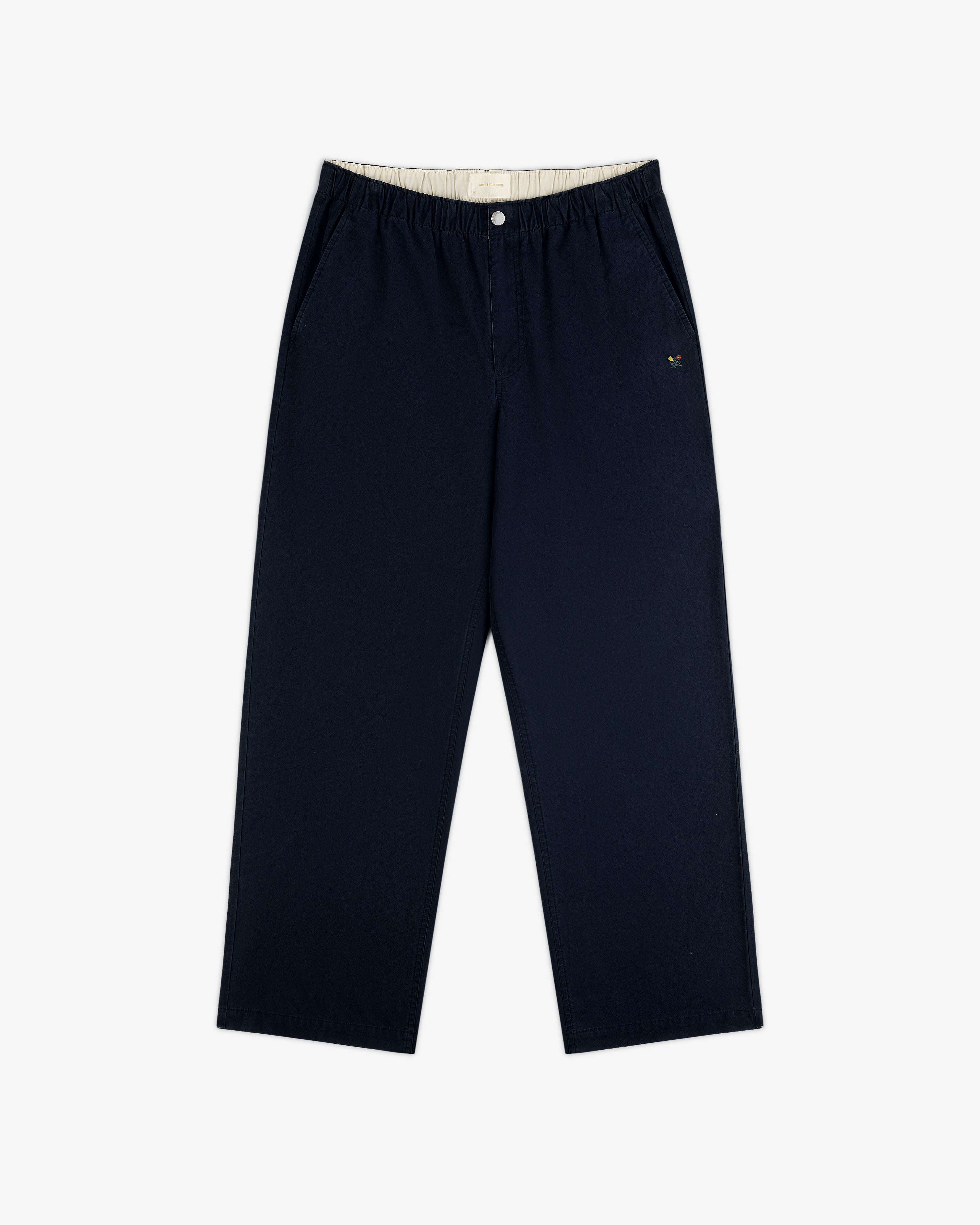 Washed Cotton Windbreaker Pant in navy with wide legs, elastic waist, side pockets, and embroidered logo by left pocket.