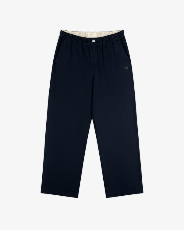 Washed Cotton Windbreaker Pant in navy with wide legs, elastic waist, side pockets, and embroidered logo by left pocket.