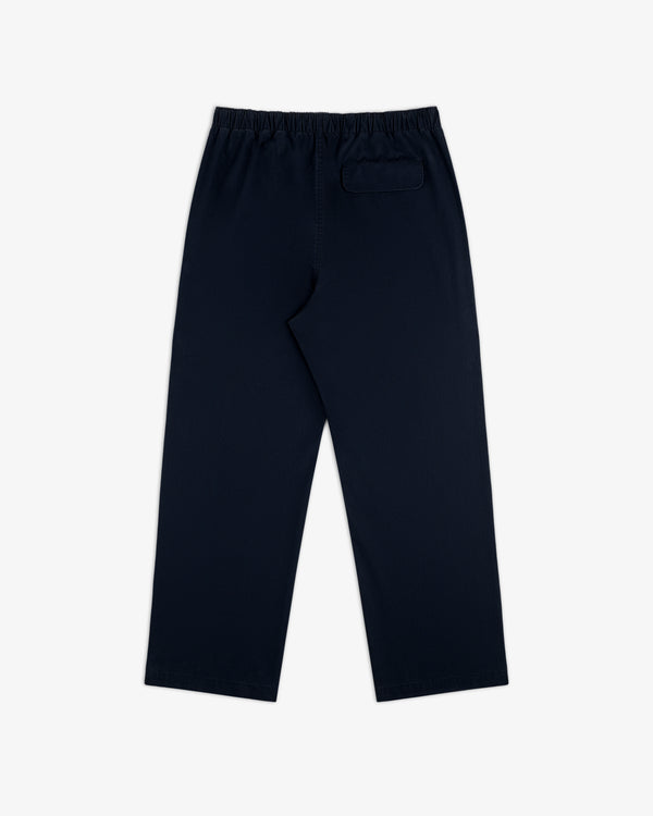 Washed Cotton Windbreaker Pant in navy blue with elastic waistband and a single back pocket, on white background.