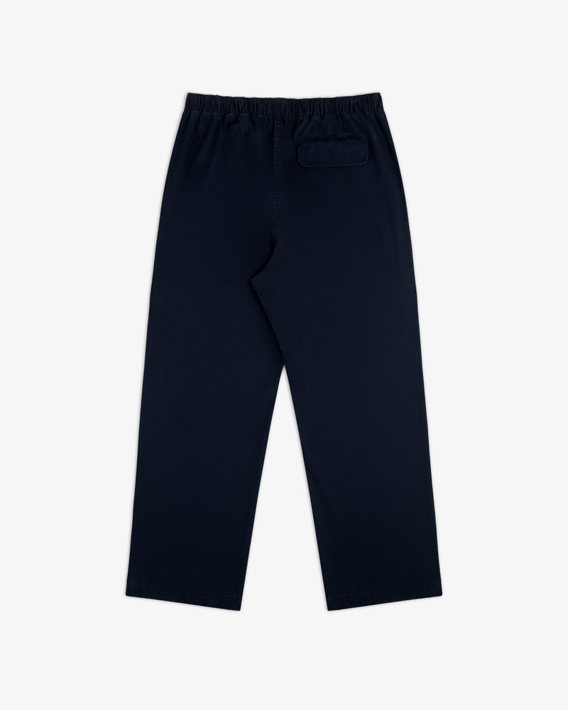 Washed Cotton Windbreaker Pant in navy blue with elastic waistband and a single back pocket, on white background.