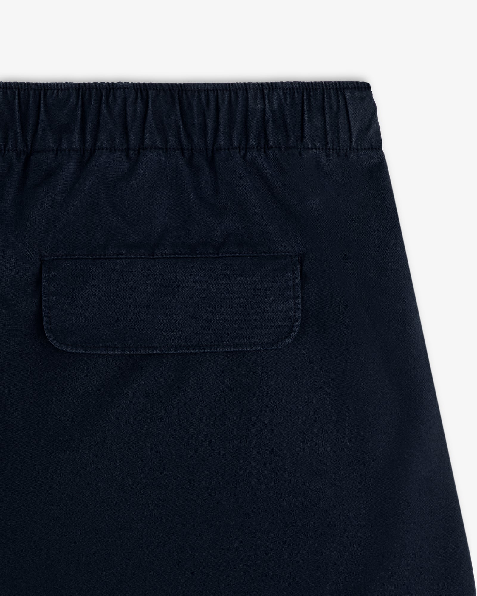 Close-up of the back of the Washed Cotton Windbreaker Pant featuring an elastic waistband and single flap pocket.