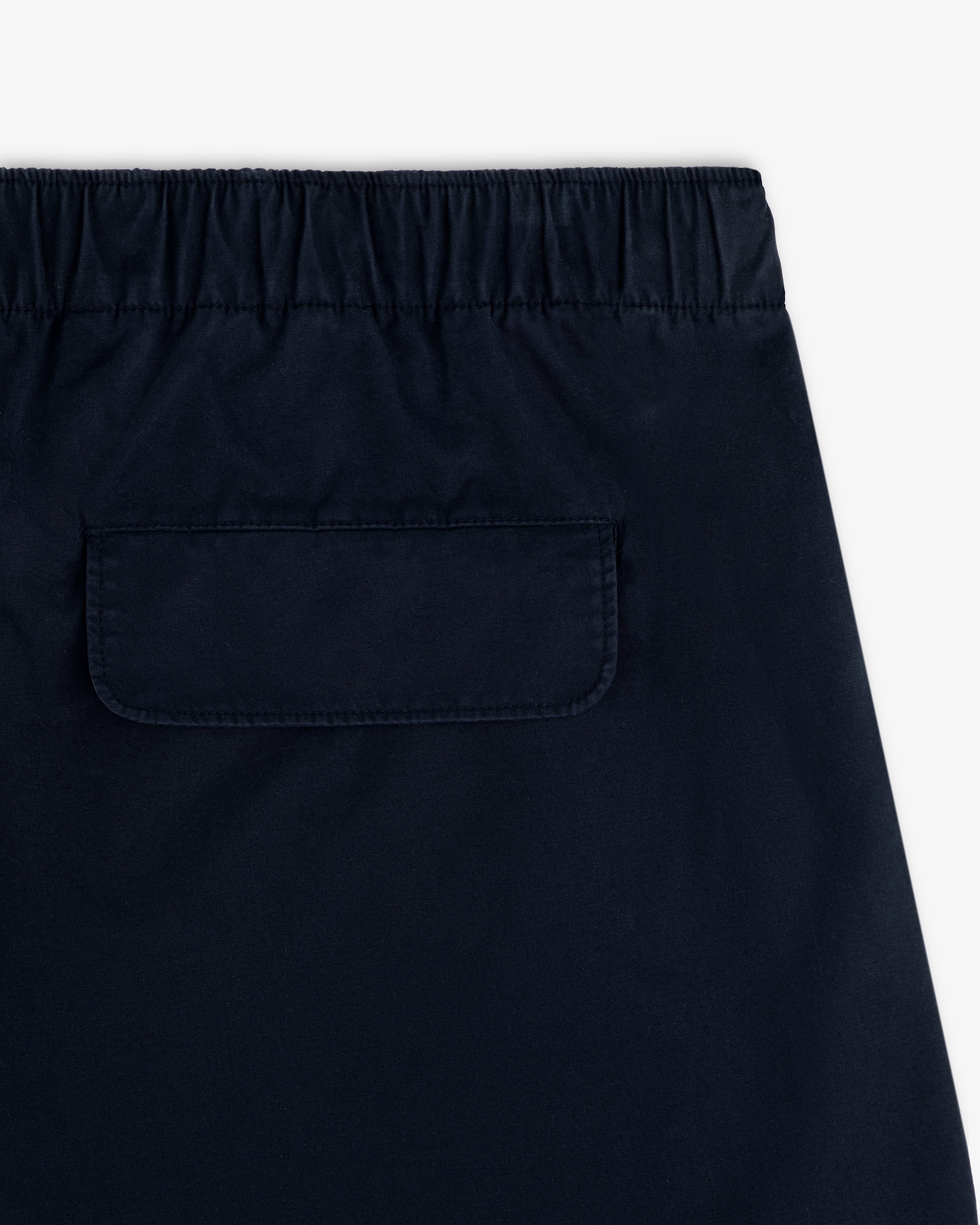 Close-up of the back of the Washed Cotton Windbreaker Pant featuring an elastic waistband and single flap pocket.