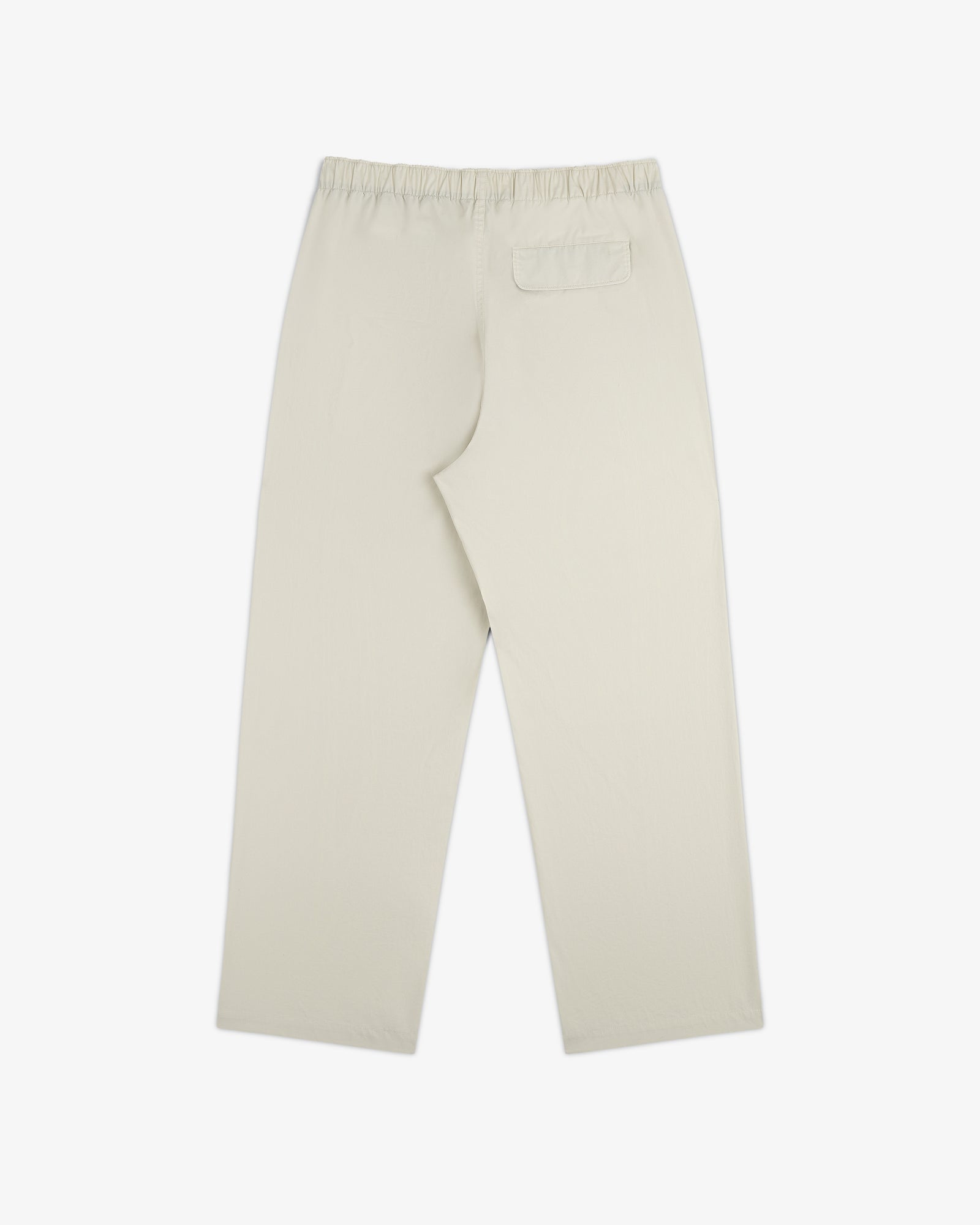 Washed Cotton Windbreaker Pant in beige with elastic waistband and one back pocket, shown flat on white.