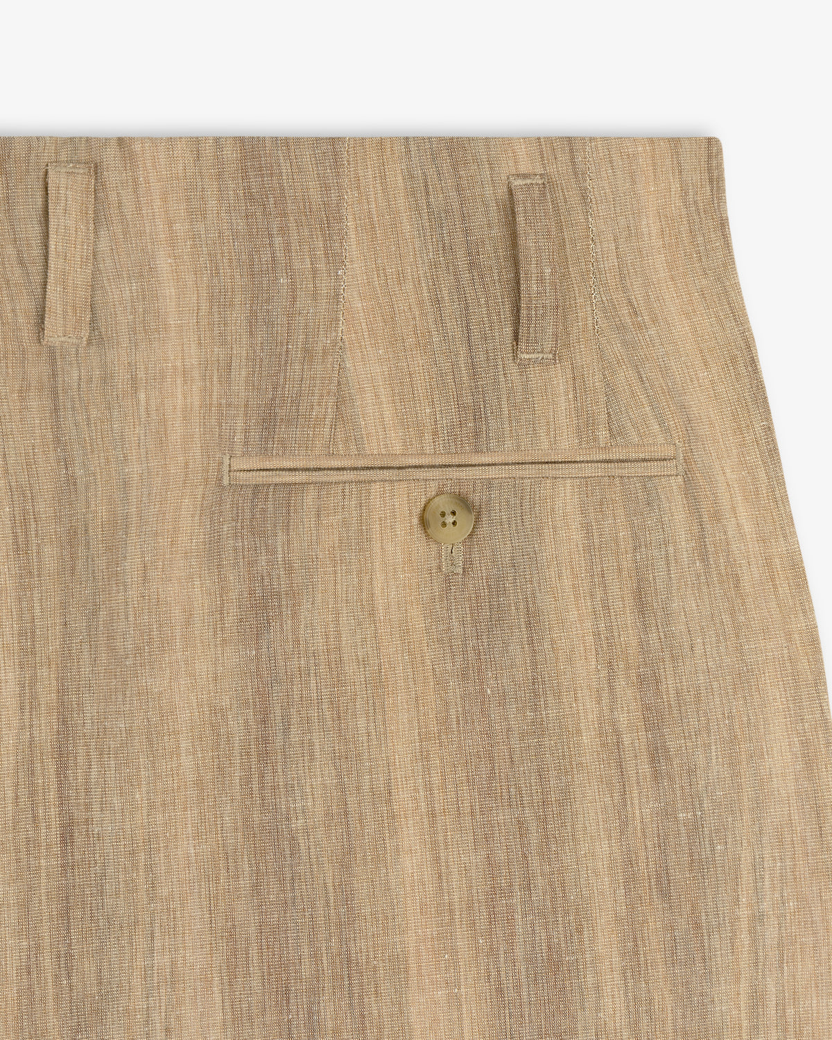 Close-up of Double Pleated Safari Suit Trouser in tan linen, featuring a single back pocket and two belt loops.