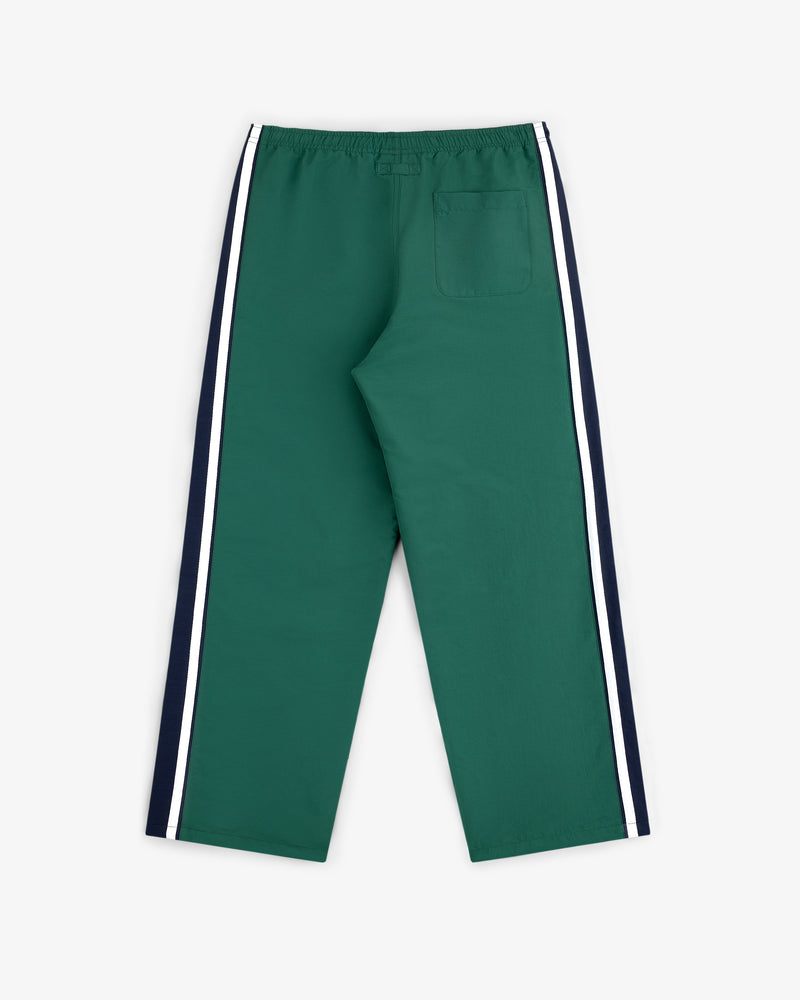 Colorblock Track Pant: green with navy and white side stripes, elastic waistband, single back pocket, shown flat on white.