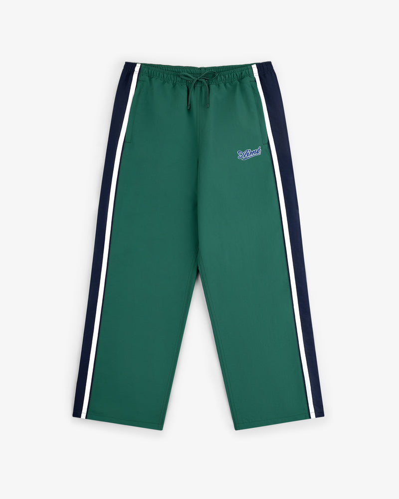 Colorblock Track Pant in green with navy panels, white stripes, and small left thigh logo, laid flat on white background.