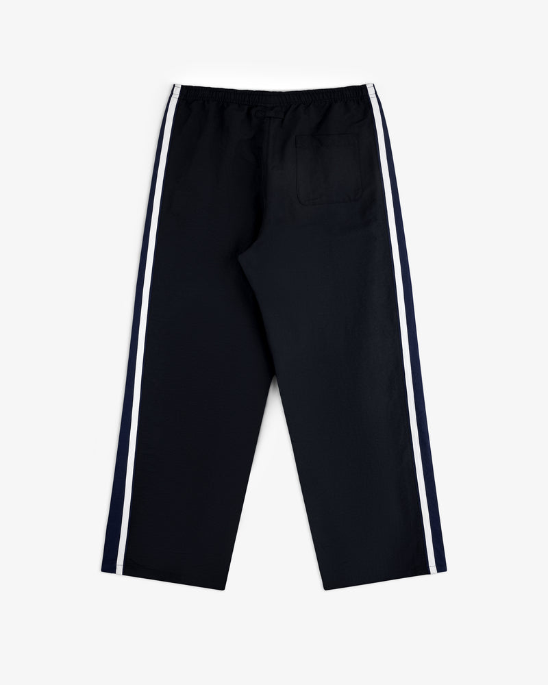 Colorblock Track Pant in black with white side stripes, elastic waistband, single back pocket, on white background.
