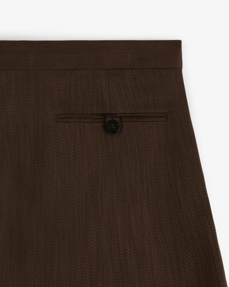 Close-up of the back pocket with button closure on the Linen Blend Suit Trouser in dark brown.