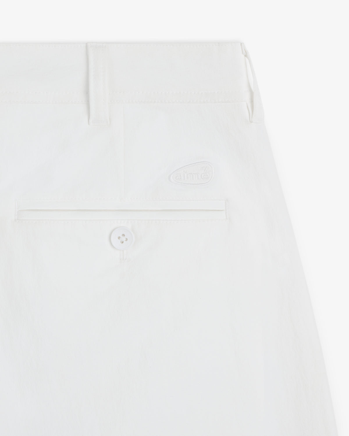 Close-up of the ALD Golf Cordura Double Pleated Pant showing a back pocket with button and embroidered logo above.