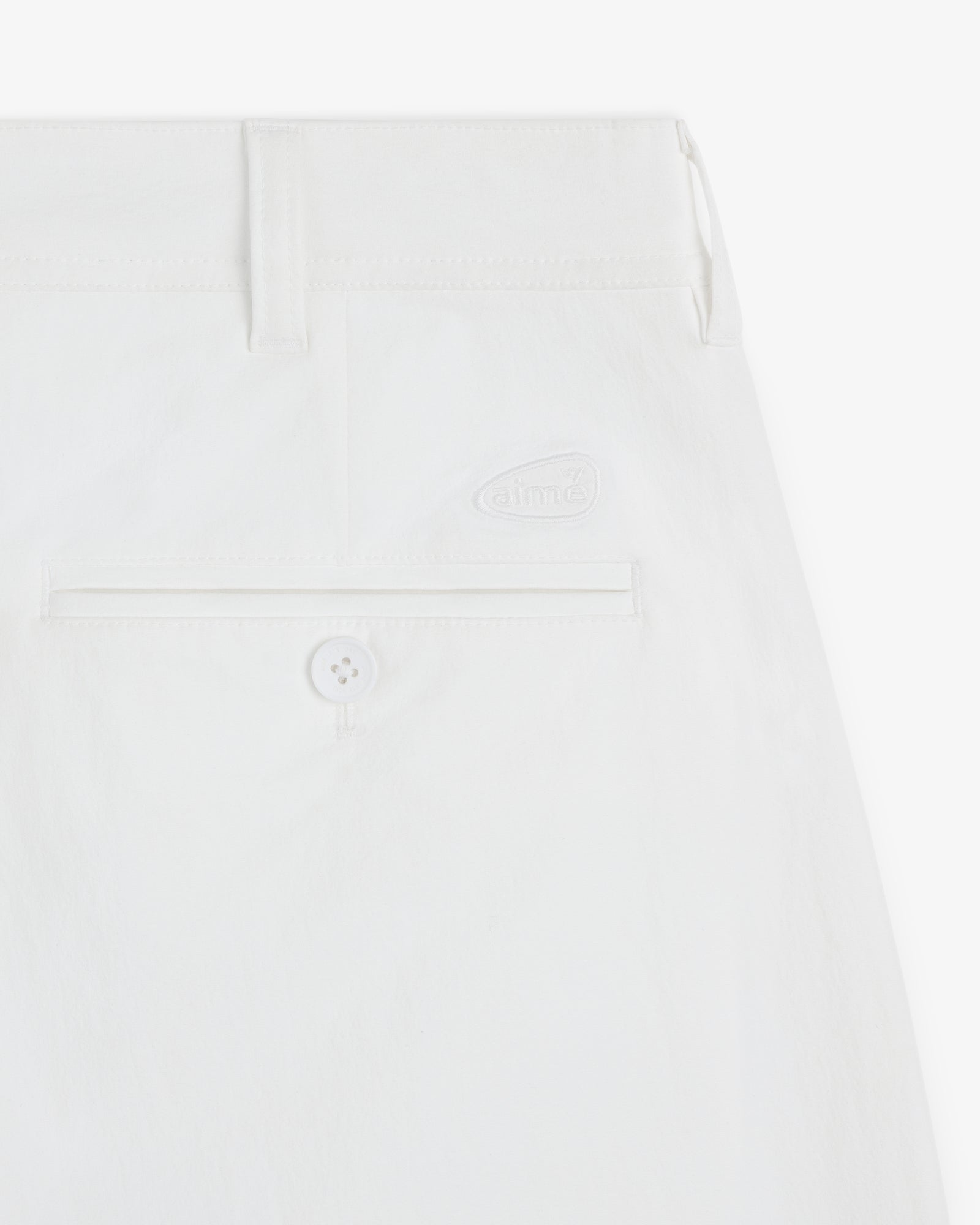 Close-up of the ALD Golf Cordura Double Pleated Pant showing a back pocket with button and embroidered logo above.