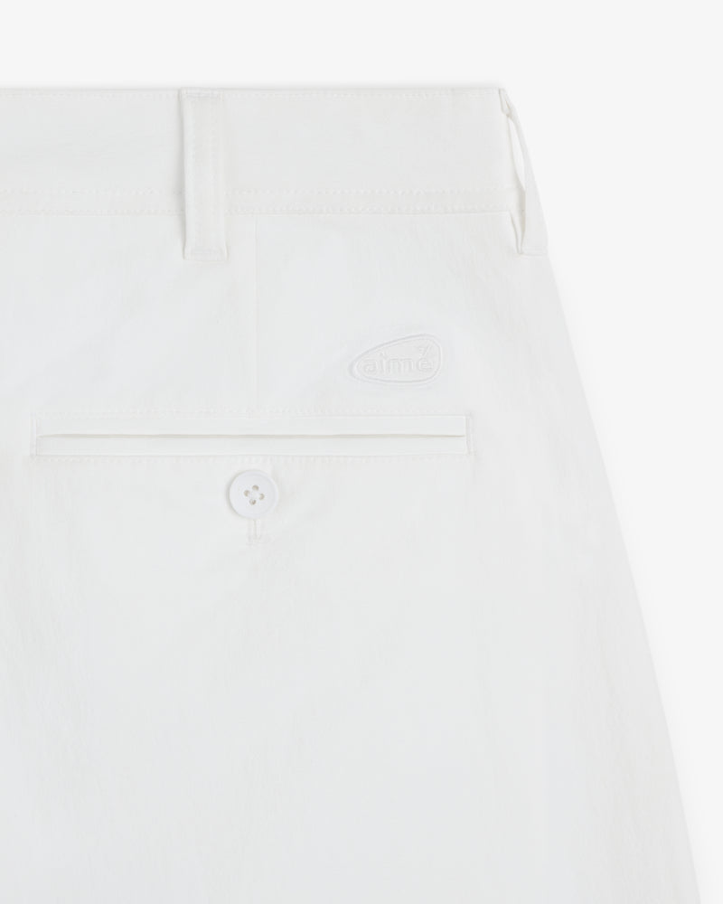 Close-up of the ALD Golf Cordura Double Pleated Pant showing a back pocket with button and embroidered logo above.