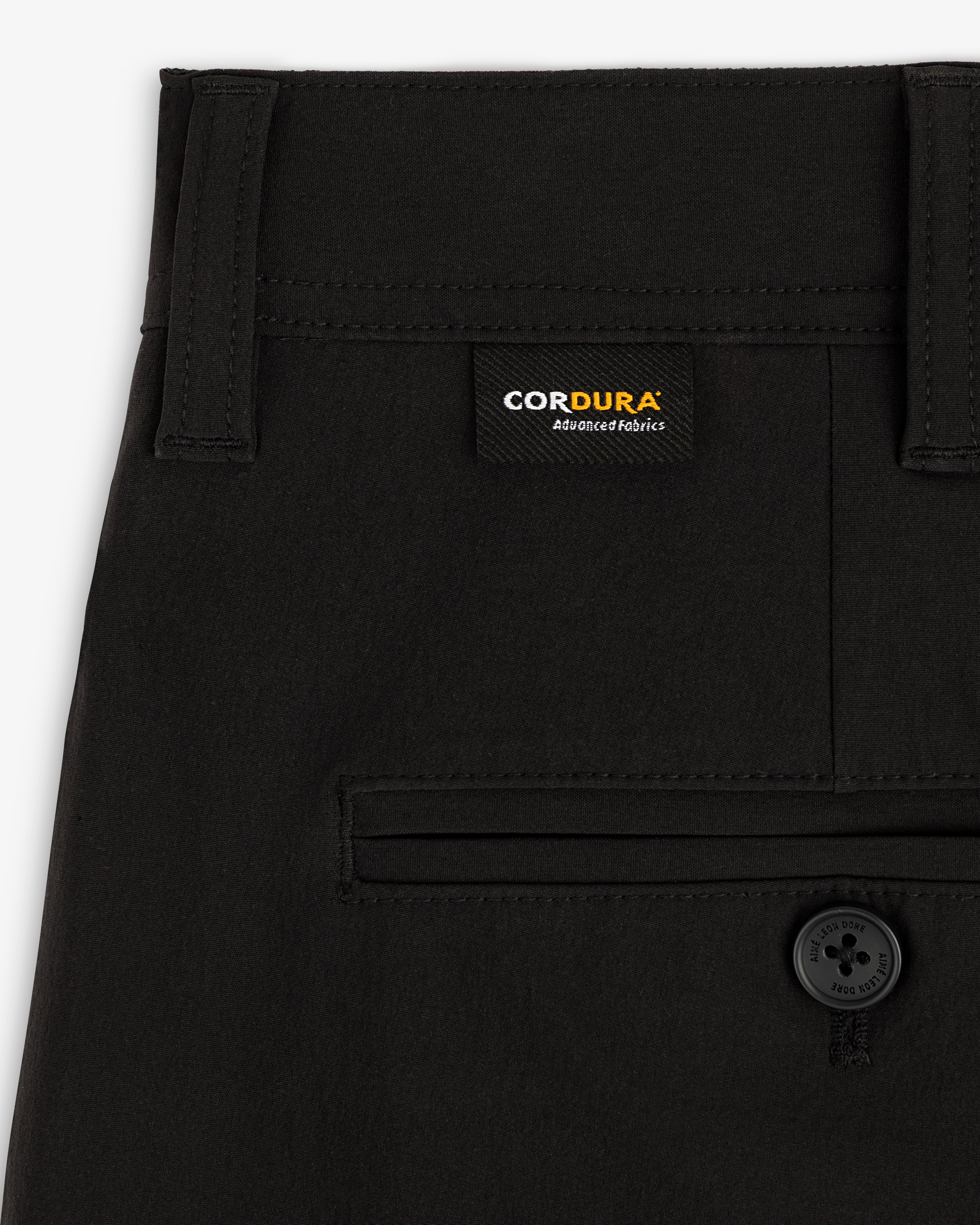 Close-up of ALD Golf Cordura Double Pleated Pant with Cordura label and single back pocket with black button.