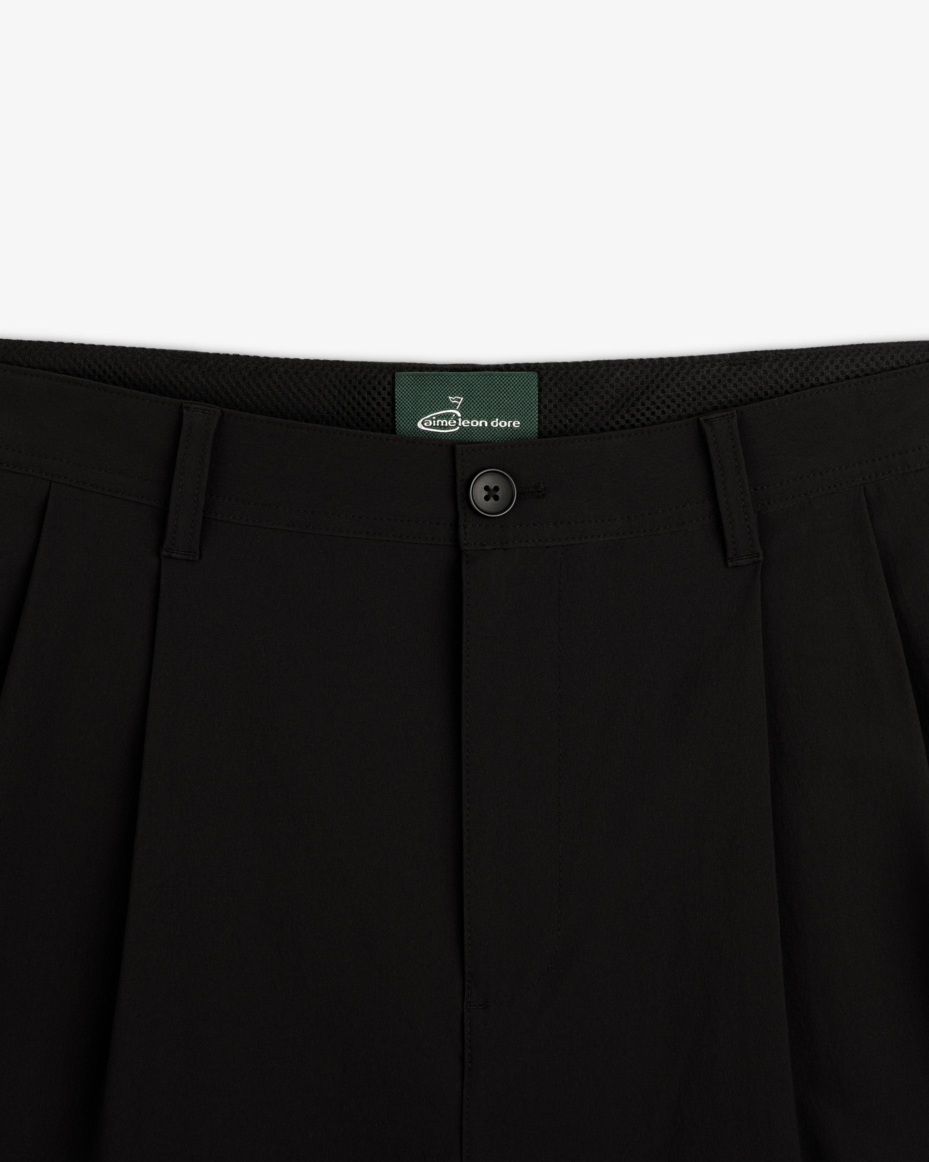 Close-up of waistband and button closure on ALD Golf Cordura Double Pleated Pant with green inner label.