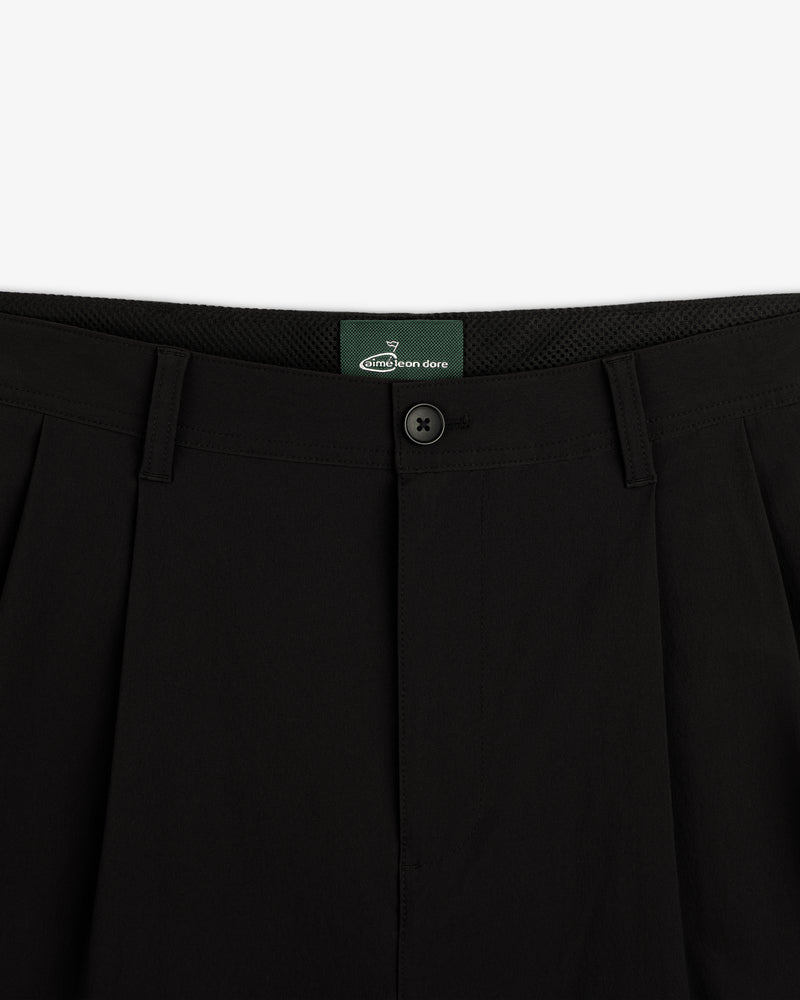 Close-up of waistband and button closure on ALD Golf Cordura Double Pleated Pant with green inner label.