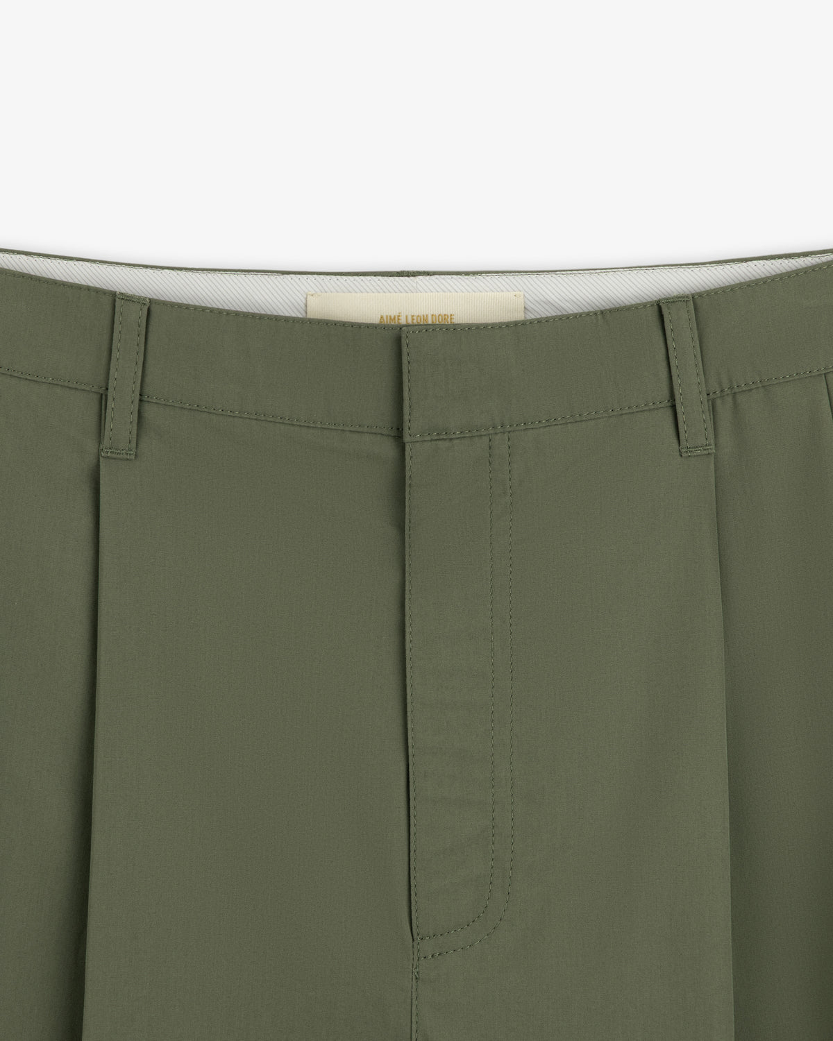Close-up of the waistband and fly of Lightweighted Pleated Cotton Trouser with belt loops and visible stitching.