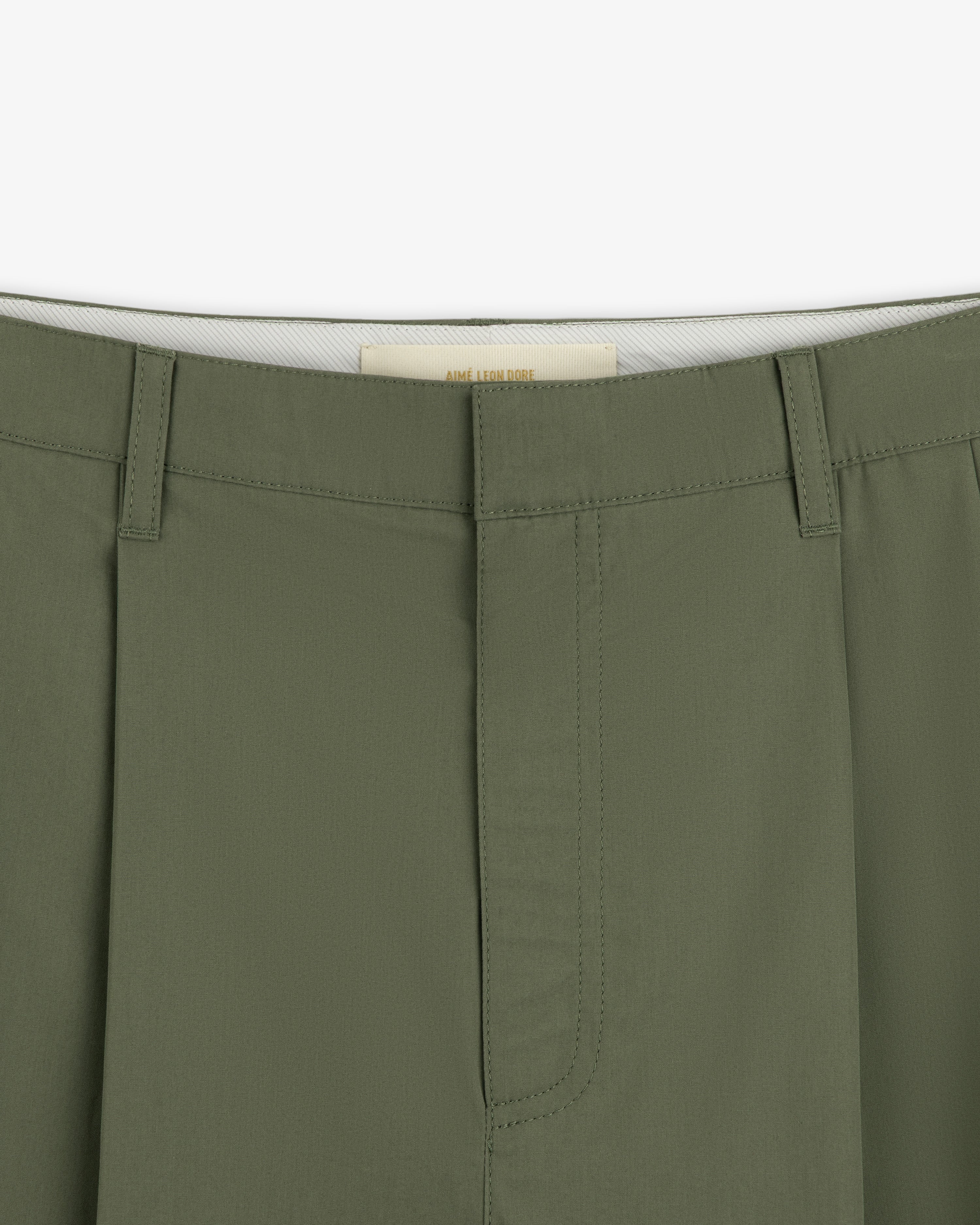 Close-up of the waistband and fly of Lightweighted Pleated Cotton Trouser with belt loops and visible stitching.