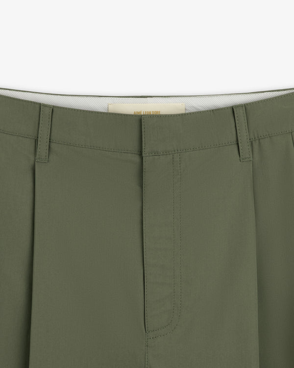 Close-up of the waistband and fly of Lightweighted Pleated Cotton Trouser with belt loops and visible stitching.