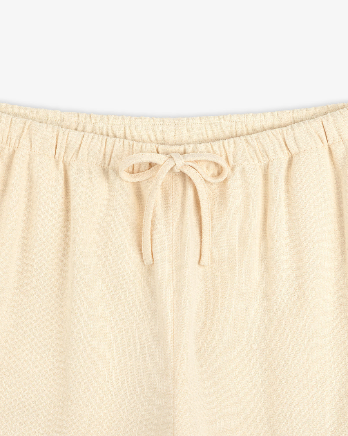 Close-up of Drawstring Cotton Blend Suit Trouser featuring an elastic waistband and a tied bow at the front.