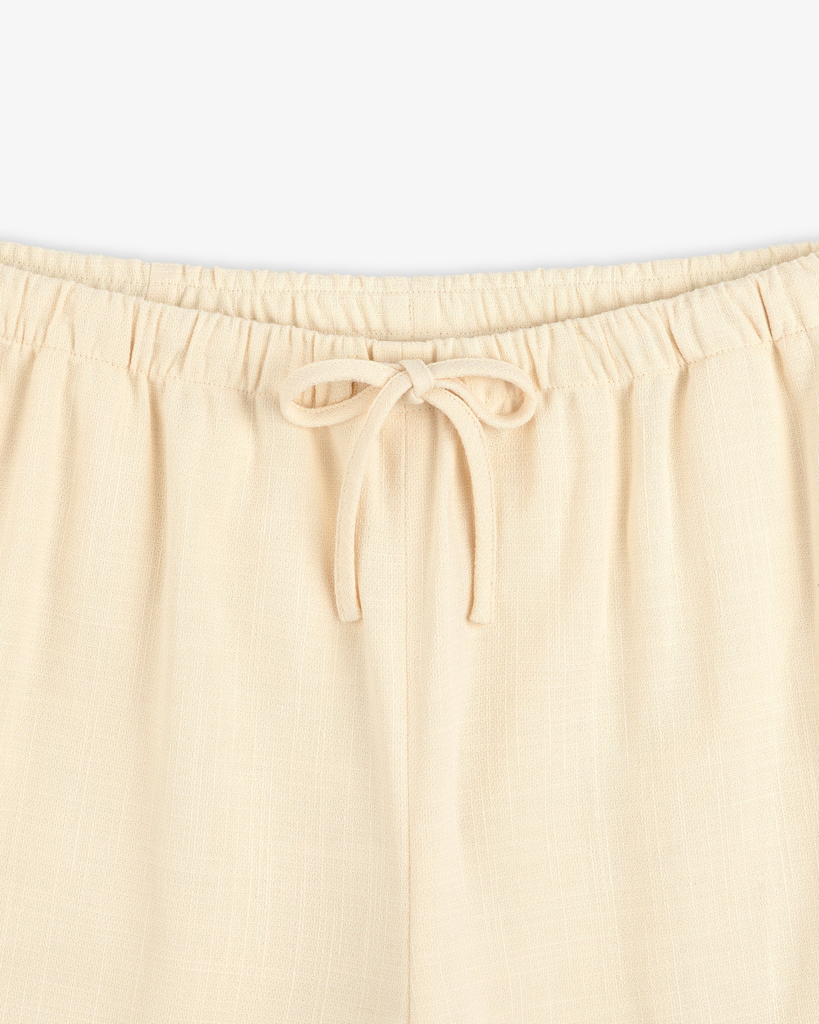 Close-up of Drawstring Cotton Blend Suit Trouser featuring an elastic waistband and a tied bow at the front.