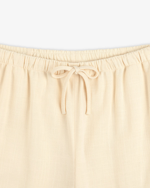 Close-up of Drawstring Cotton Blend Suit Trouser featuring an elastic waistband and a tied bow at the front.