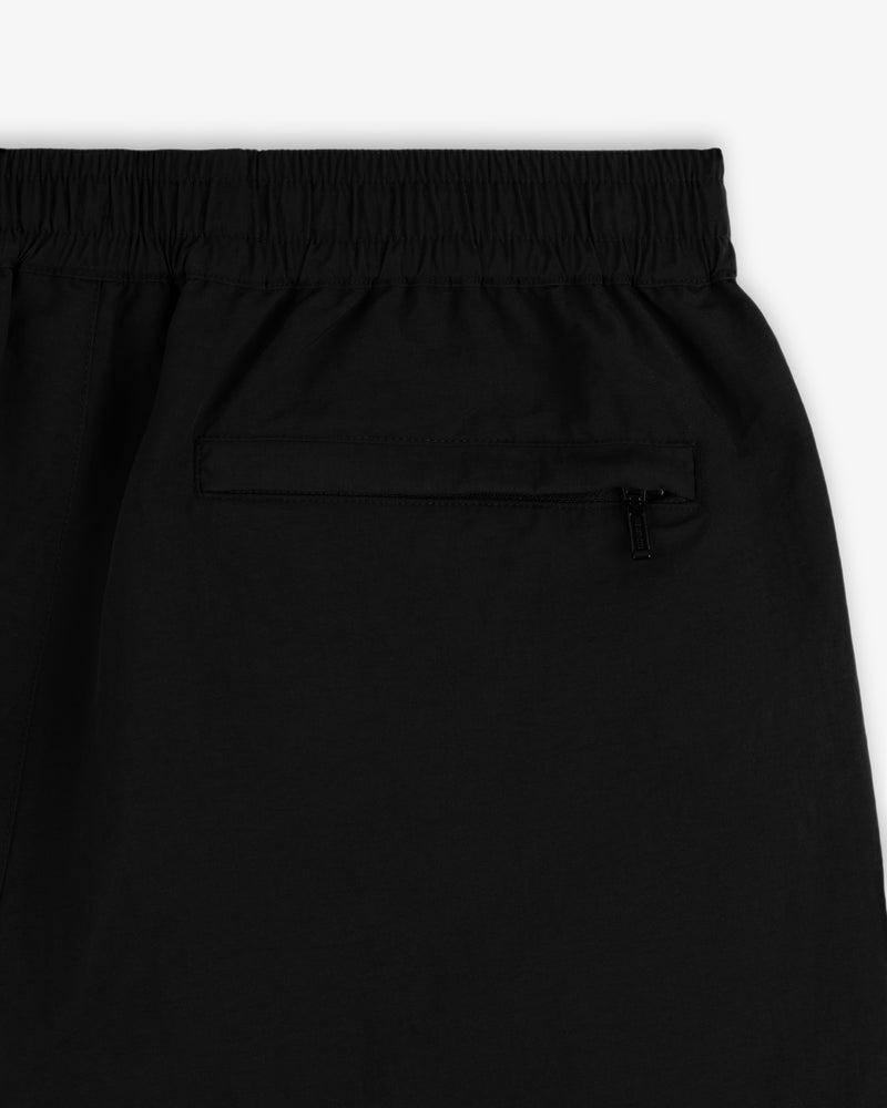Close-up of Crest Nylon Track Pant in black with elastic waistband and zippered back pocket.