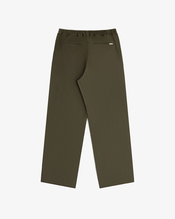 Linen Leisure Pant in olive green with wide legs, elastic waistband, and two back welt pockets on a white background.
