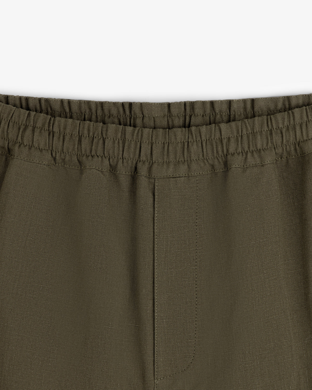 Close-up of Linen Leisure Pant in olive green featuring an elastic waistband and visible seam details.