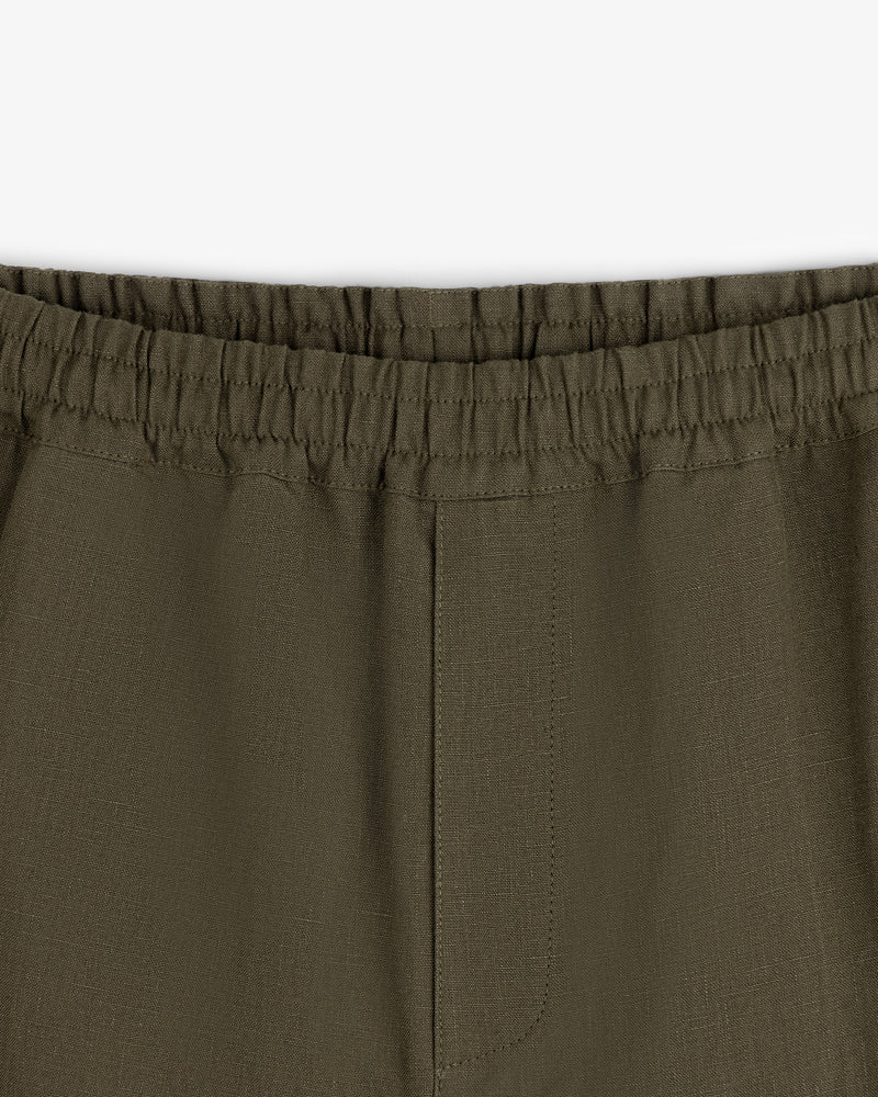 Close-up of Linen Leisure Pant in olive green featuring an elastic waistband and visible seam details.