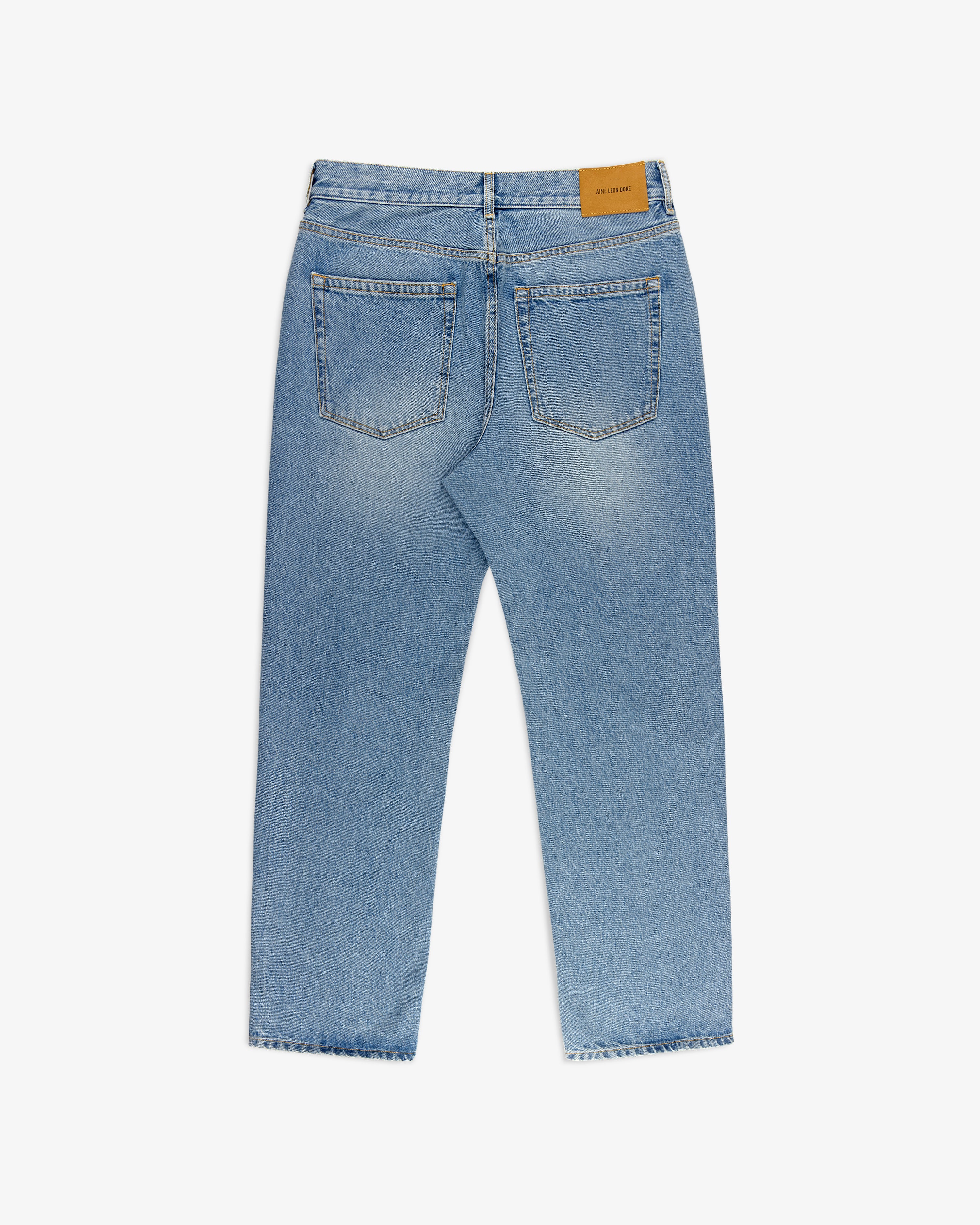 Back view of ALD Straight Fit Denim in light blue with two back pockets and a brown leather waistband patch.