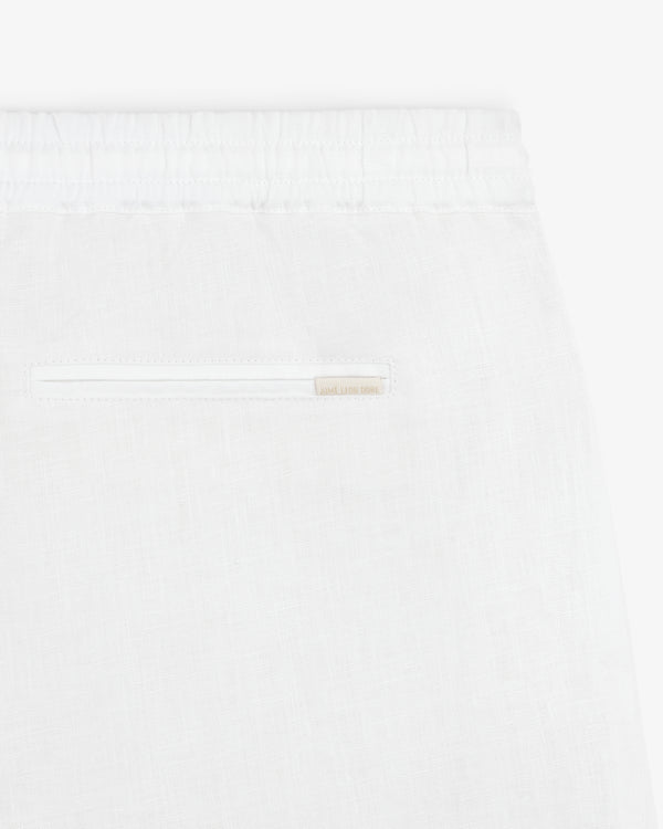 Close-up of Linen Leisure Pant in white, featuring an elastic waistband and a single back pocket.