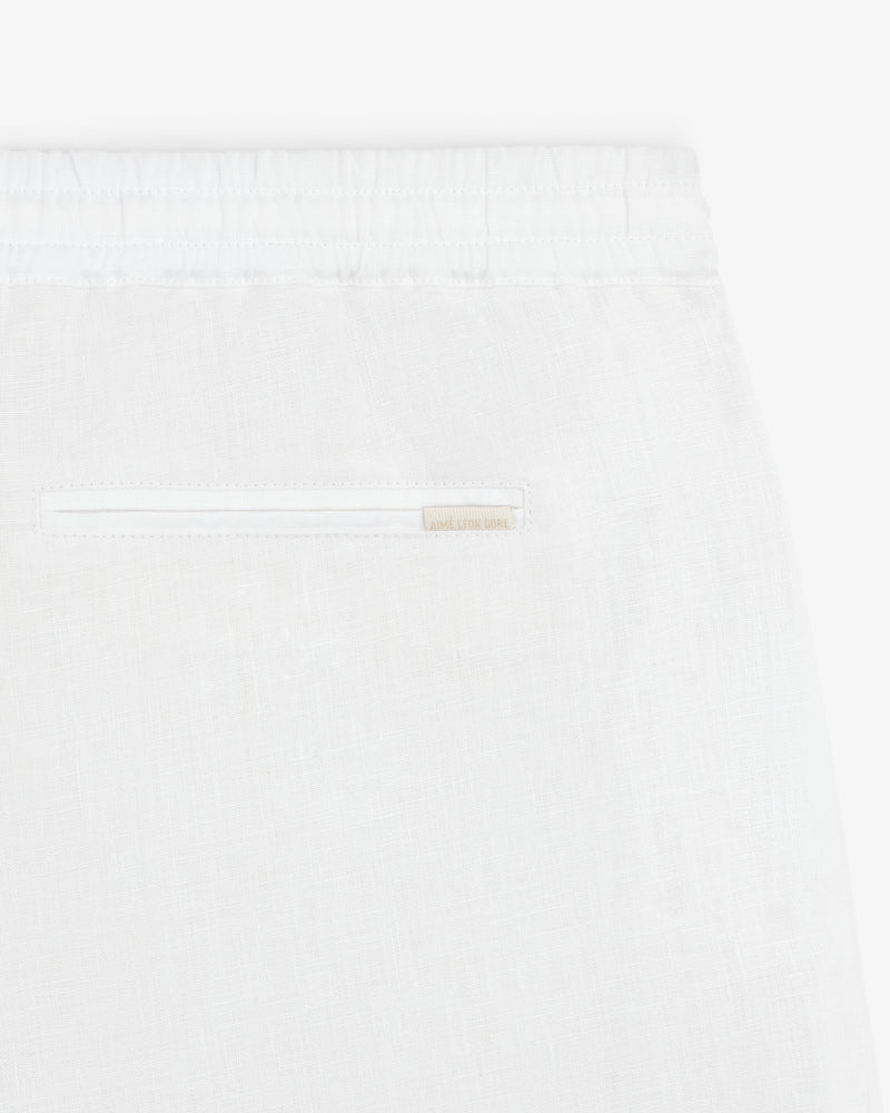 Close-up of Linen Leisure Pant in white, featuring an elastic waistband and a single back pocket.